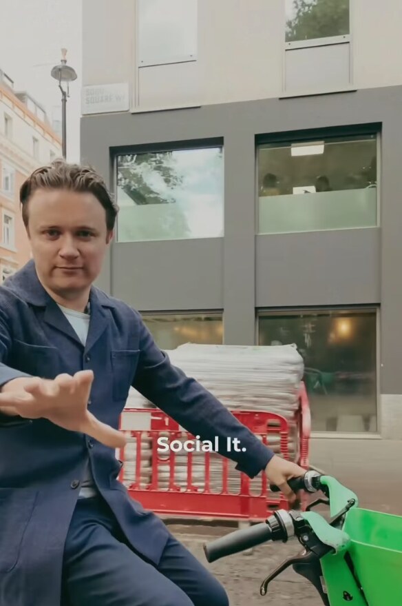 Rory, CEO of The Moment, on a bike outside an office in London